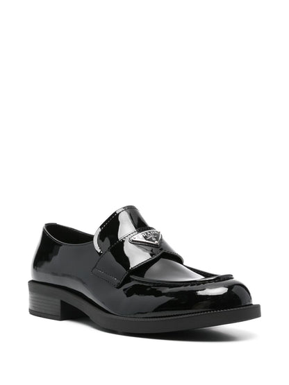 Black triangular logo leather loafers
